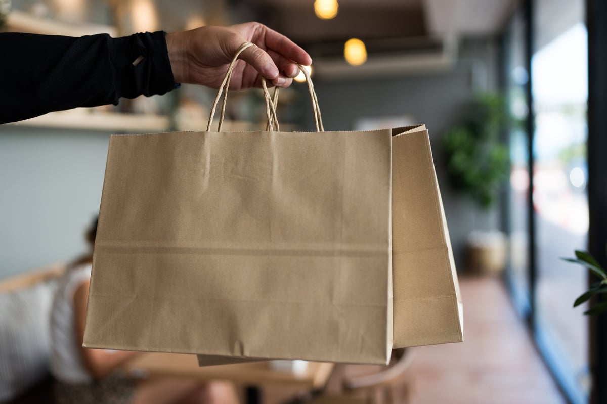 Printed paper bag holding a bakery order
