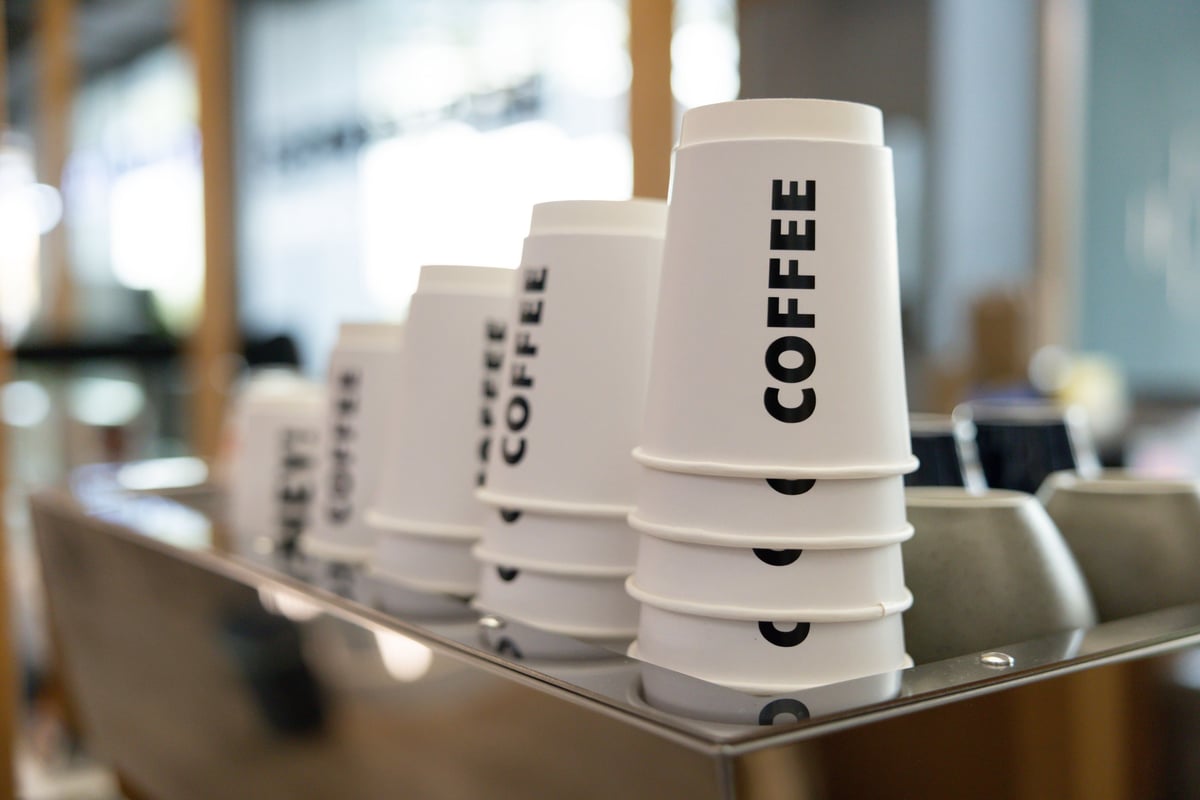 Row of custom printed coffee cups