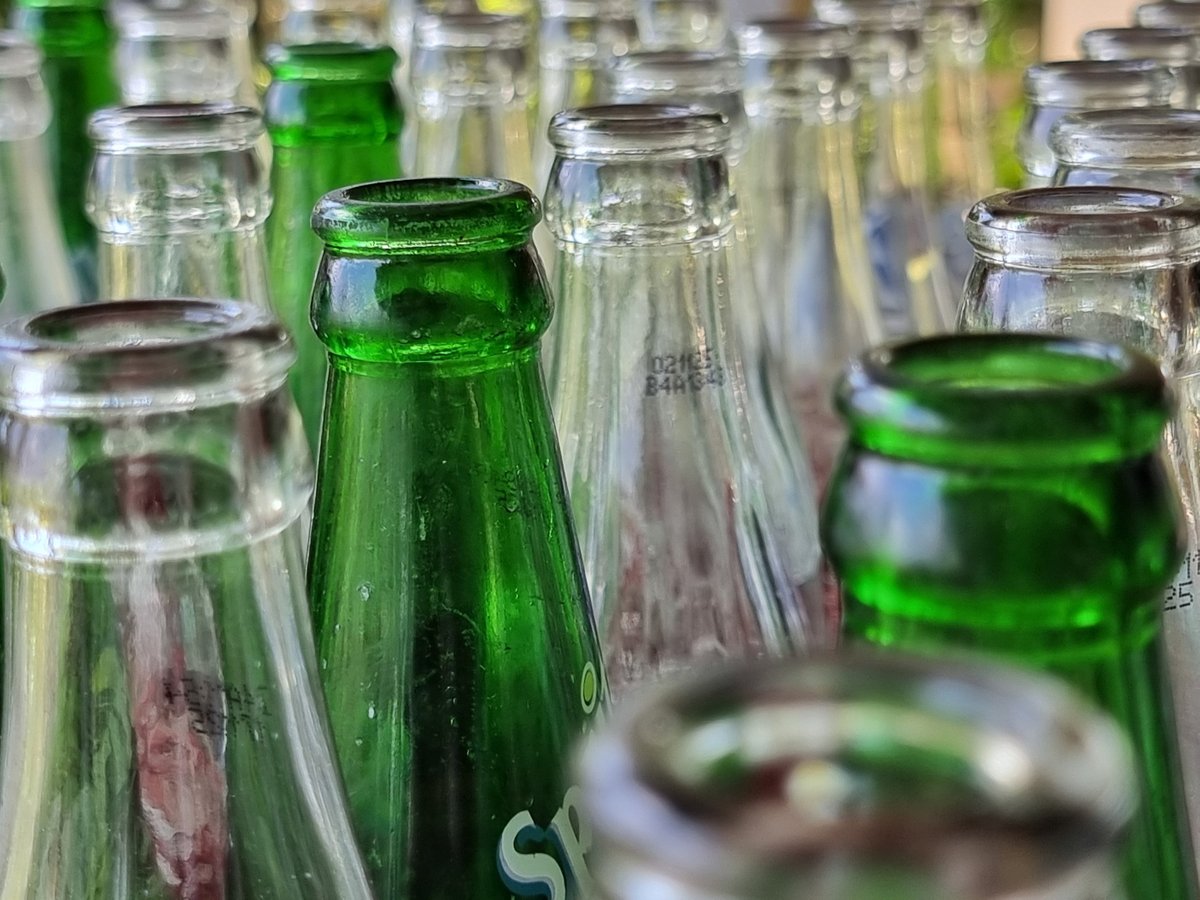 Rows of clear glass bottles ready for filling and labelling