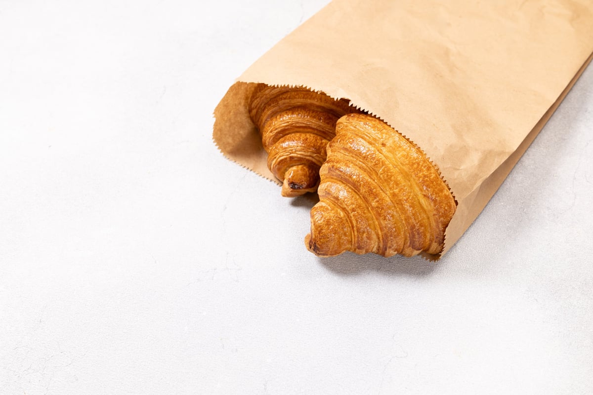 Loaves of bread in printed paper bags
