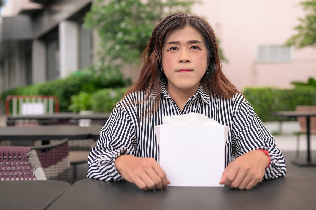 Customer holding a printed takeout paper bag